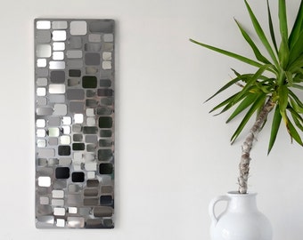 Stainless steel wall sculpture forming a model C mosaic