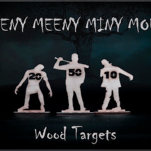 May include: Three wooden zombie targets with different point values: 10, 20, and 50. The targets are cut out of wood and have a rustic look. The text "Eeny Meeny Miny Moe" is at the top of the image, and the text "Wood Targets" is at the bottom.