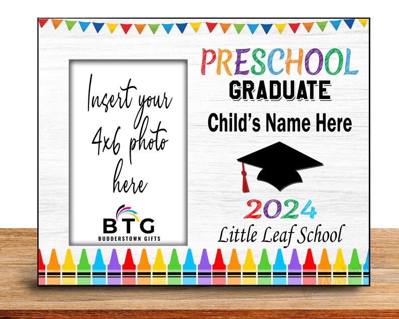 May include: A white wooden picture frame with colorful crayon and banner accents. The frame is designed for a 4x6 photo and features the text "Preschool Graduate Child's Name Here 2024 Little Leaf School."