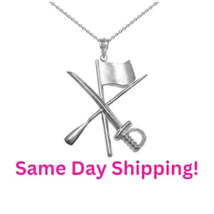 May include: Silver necklace with a pendant featuring a crossed sword, oar, and flag. The pendant is a symbol of the color guard.