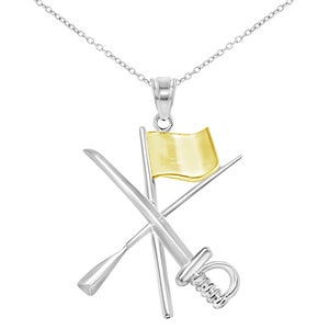 May include: A silver necklace with a pendant featuring a gold flag, a sword, and a paddle crossed together.