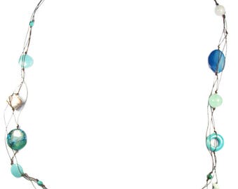 May include: A multi-strand necklace with blue, green, and white beads. The necklace is made of brown cord and features various shapes and sizes of beads.