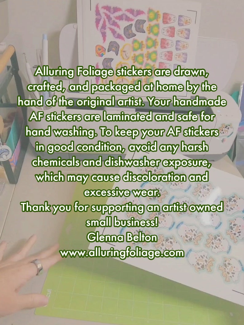 May include: A sheet of stickers featuring various designs, including a snowman, a cat, and a fish. The stickers are drawn, crafted, and packaged at home by the original artist. The text on the sheet reads: "Alluring Foliage stickers are drawn, crafted, and packaged at home by the hand of the original artist. Your handmade AF stickers are laminated and safe for hand washing. To keep your AF stickers in good condition, avoid any harsh chemicals and dishwasher exposure, which may cause discoloration and excessive wear. Thank you for supporting an artist owned small business! Glenna Belton www.alluringfoliage.com"