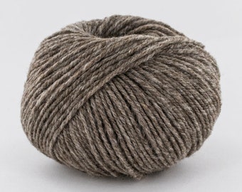 May include: A ball of brown yarn with a slightly mottled texture.