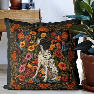 May include: A black throw pillow with a floral pattern and a black and white dog illustration. The dog is sitting and looking to the left. The floral pattern includes red, orange, yellow, and green flowers.