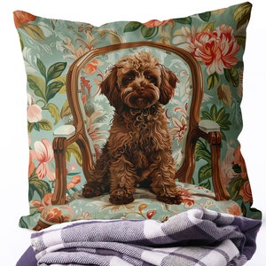 Peut inclure: Un caniche brun assis dans un fauteuil à motifs floraux. Le fauteuil a un fond bleu clair avec des fleurs roses et vertes. Le chien regarde directement la caméra.
