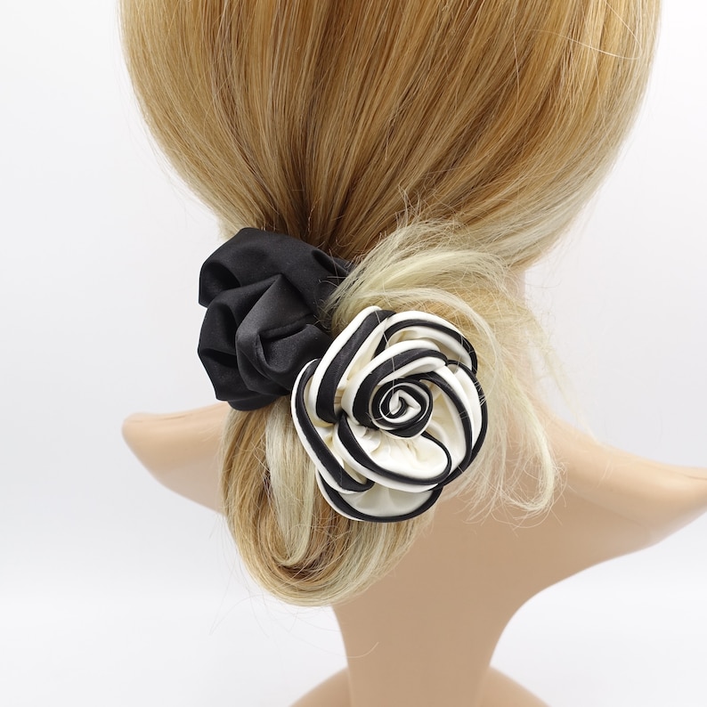 May include: Black and white striped fabric rose hair clip with a black scrunchie.