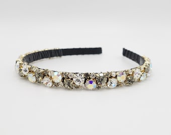 May include: A black headband with a row of clear and gray rhinestones.