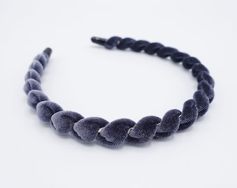 May include: A dark grey velvet headband with a braided design.