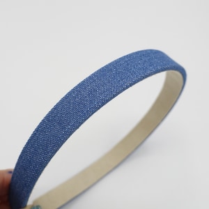 May include: A blue denim headband with a white elastic band.
