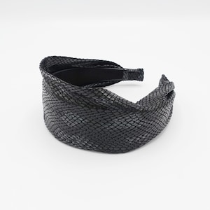 May include: Black headband with a snakeskin pattern.