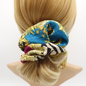 May include: A blue, gold, and white patterned hair scrunchie with a zebra print design.