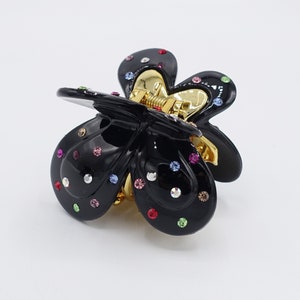 May include: Black butterfly-shaped hair clip with colourful rhinestones.