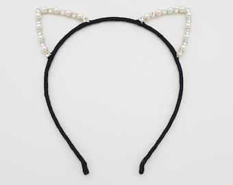 May include: Black headband with pearl and rhinestone cat ears.