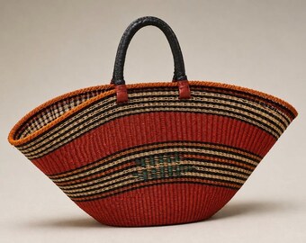 May include: A wide, boat-shaped woven basket bag featuring horizontal stripes in shades of red, black, and tan. The bag has two black, textured leather-like handles attached with red leather tabs, and a small green woven detail on the front.