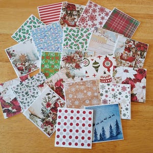 May include: A collection of square Christmas-themed paper sheets with various patterns. Designs include red and white stripes, snowflakes, holly, plaid, floral arrangements, and Santa Claus. The color palette features red, green, white, and blue.