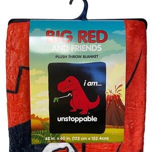 May include: A red plush throw blanket featuring a cartoon dinosaur with the text "BIG RED AND FRIENDS" and "I am... unstoppable". The blanket measures 48 inches by 60 inches (122 cm x 152.4 cm).