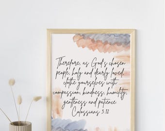 May include: A framed print with a light wood frame. The print features watercolor-style artwork in shades of peach, gray, and blue. The text reads "Therefore, as God's chosen people..." from Colossians 3:12.
