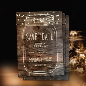 May include: A rustic save the date card with a mason jar design. The jar is outlined in white and has string lights inside. The text reads "The Save the Date, Saturday April 6th, 2019, Abram & Julie are getting married, Burnet, TX."