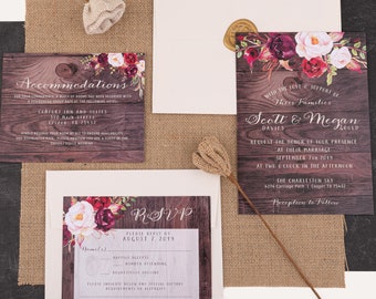 May include: Rustic wedding invitation suite with floral accents. The invitation features a woodgrain background with burgundy and pink flowers. The text reads "With the love and support of their families, Scott & Megan request the honor of your presence at their marriage, September 7th, 2019, at two o'clock in the afternoon, The Charleston Sky, 4274 Carriage Path | Cooper TX 75432, Reception to follow."
