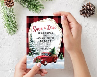 May include: Save the date card with a red and black buffalo plaid background. The card features a red vintage pickup truck with a Christmas tree in the bed, driving through a snowy winter scene. The text on the card reads "Save the Date", "Leisa Brown and Antonio Castro", "10.16.21", "Huntley, Illinois", and "Formal Invitation to Follow".