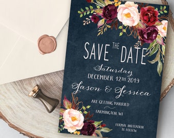 May include: Save the date card with a navy blue background and watercolor floral design in shades of burgundy, pink, and green. The text reads "Save the Date" with the date "Saturday, December 12th, 2019" and the names "Jason & Jessica".