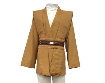 May include: A brown Jedi robe with a brown belt and white undershirt. The robe has a long, flowing design and is worn over white pants and brown boots.