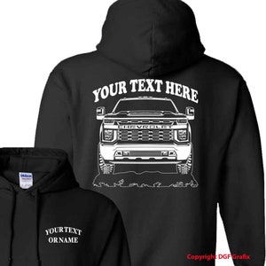 May include: Black hooded sweatshirt with a white outline of a Chevrolet pickup truck on the back. The text "YOUR TEXT HERE" is above the truck. The front of the sweatshirt has the text "YOUR TEXT OR NAME" in white.