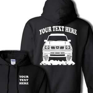 May include: Black hoodie with a white outline of a Nissan truck and the text "YOUR TEXT HERE" on the back. The front of the hoodie has the text "YOUR TEXT HERE" in white.