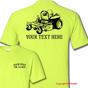 May include: A bright yellow t-shirt with a black silhouette of a riding lawnmower on the back. The text "YOUR TEXT HERE" is printed below the lawnmower. The front of the shirt has the text "YOUR TEXT OR NAME" printed on it.