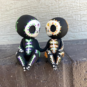 Figura de pareja de calaveras de azúcar tomadas de la mano, pintada a mano e impresa en 3D