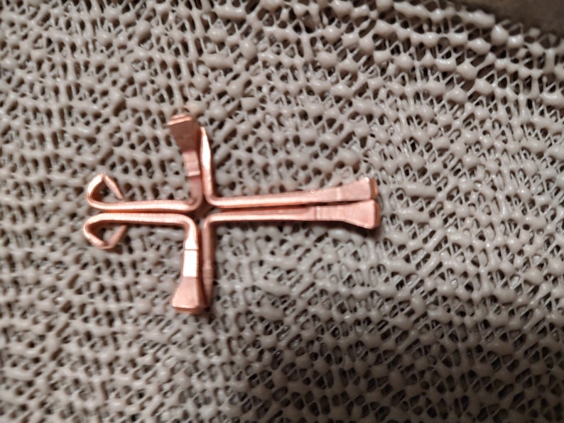 Four steel horse shoe nails electroplated with real copper and precision bent