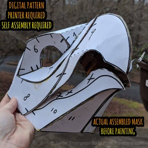 May include: A white paper mask pattern with numbered pieces, ready to be assembled. The text "DIGITAL PATTERN", "PRINTER REQUIRED", "SELF ASSEMBLY REQUIRED", "ACTUAL ASSEMBLED MASK", and "BEFORE PAINTING" is printed on the paper.