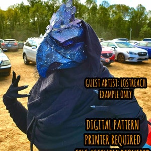 May include: A person wearing a black hooded cloak and a blue and white mask with a galaxy design. The text "GUEST ARTIST: LOSTREACH EXAMPLE ONLY" is visible on the image. The text "DIGITAL PATTERN PRINTER REQUIRED SELF ASSEMBLY REQUIRED" is also visible on the image.