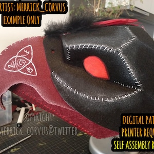 May include: A red and black felt mask with a white symbol on the side. The mask is a digital pattern that requires a printer and self assembly. The text "GUEST ARTIST: MERRICK_CORVUS EXAMPLE ONLY" is at the top of the image. The text "COPYRIGHT MERRICK_CORVUS@TWITTER" is at the bottom of the image. The text "DIGITAL PATTERN PRINTER REQUIRED SELF ASSEMBLY REQUIRED" is at the bottom right of the image.