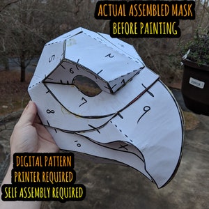 May include: A white paper mask with numbered sections, ready to be assembled and painted. The text "ACTUAL ASSEMBLED MASK BEFORE PAINTING", "DIGITAL PATTERN PRINTER REQUIRED", and "SELF ASSEMBLY REQUIRED" is printed on the mask.