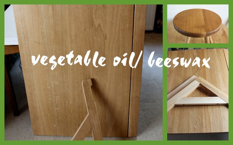 May include: Close-up of a wooden table top finished with vegetable oil and beeswax. The table is made of light brown wood and has a natural finish. The table is supported by a simple wooden frame.
