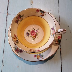 E B  Foley bone china yellow and white tea cup with floral accents