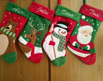 May include: Five personalized Christmas stockings with embroidered names: Alex, Julie, Diana, and Tom. Each stocking features a different festive design: a bear, a deer, a snowman, and Santa Claus.