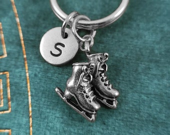May include: Silver ice skate charm keychain with a silver initial charm with the letter "S".