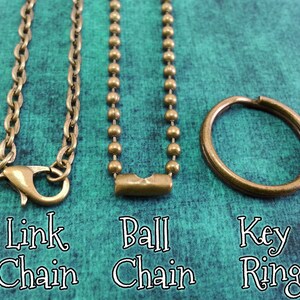 May include: Three different types of chains: a link chain, a ball chain, and a key ring. All are made of a brass-colored metal.
