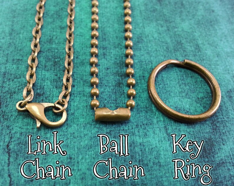 May include: Three different types of chains: a link chain, a ball chain, and a key ring. All are made of a brass-colored metal.
