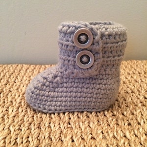 Baby booties with buttons. Gray