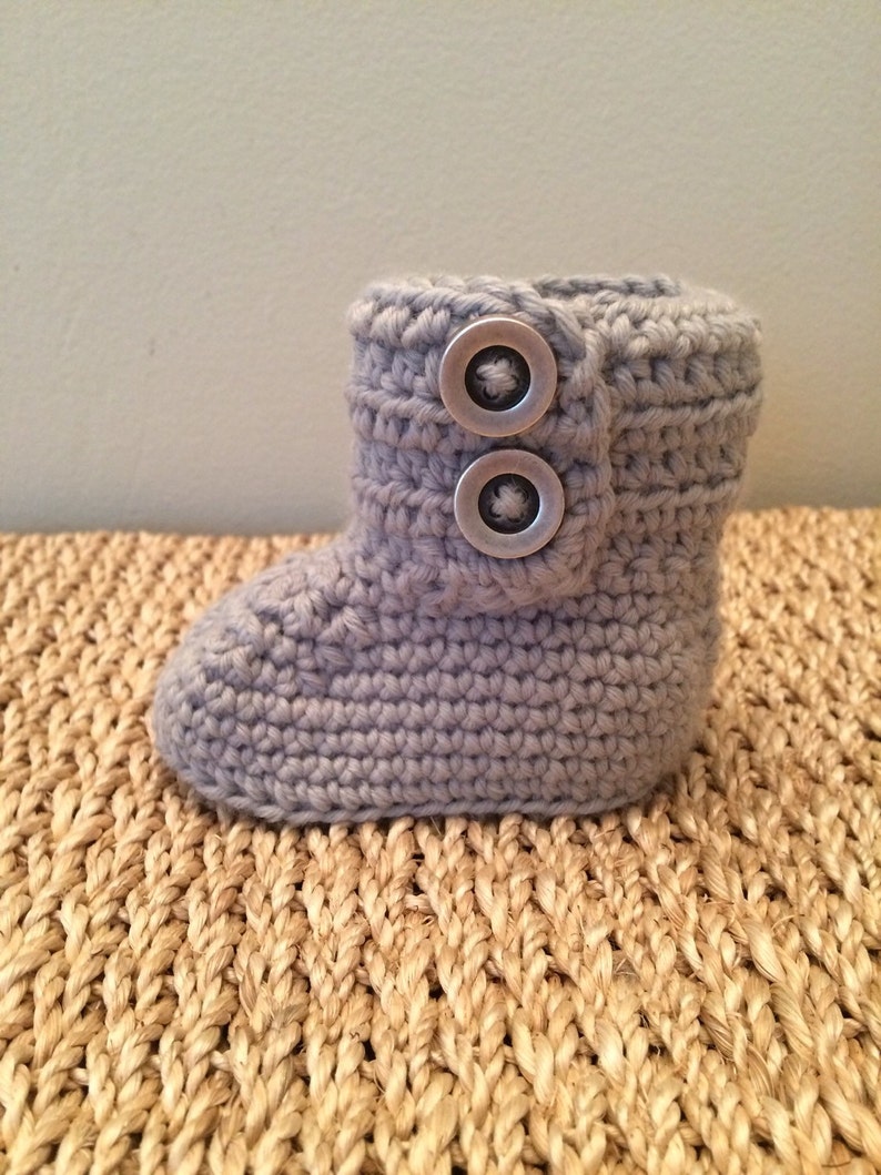 Baby booties with buttons. Gray