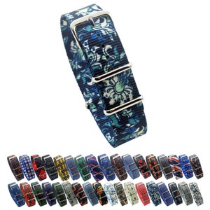 May include: A selection of colourful patterned watch straps with silver buckles. The straps are made of nylon and feature a range of floral, geometric and abstract designs.