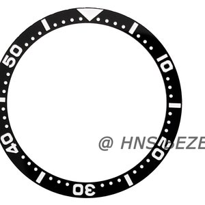 May include: Black watch bezel with white markings for the numbers 10, 20, 30, 40, and 50. The bezel has a white triangle at the top.