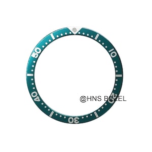 May include: A teal watch bezel with white minute markers and numerals at 10, 20, 30, 40, and 50. The circular bezel features a small silver triangle at the top. The text "@HNS BEZEL" is visible.
