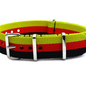 May include: A black, red, and yellow striped nylon watch strap with silver buckle and keeper.