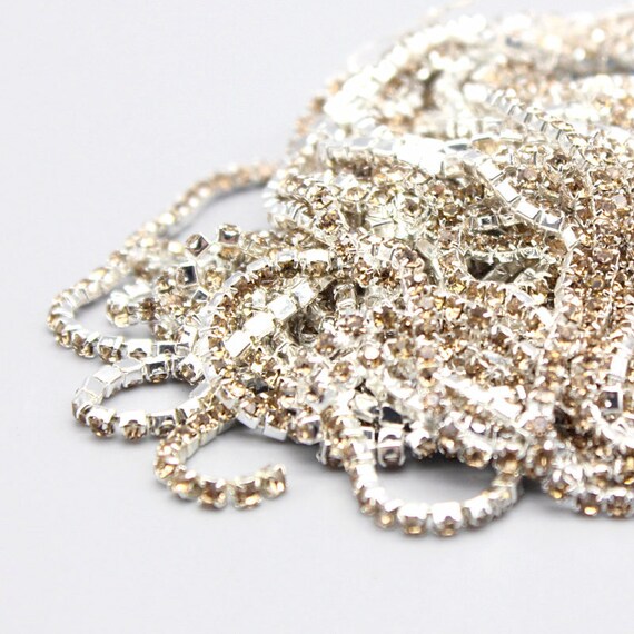 Light Gold Rhinestone Trim by yard in silver setting casing  2mm/2.5mm/2.8mm/3mm/4mm Crystal Chain,Wholesale Cheap&high Quality  (7000-47-8)