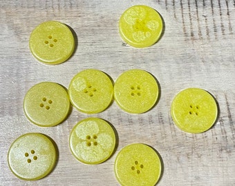 9 buttons with 4 holes in resin in yellow, 25 mm diameter